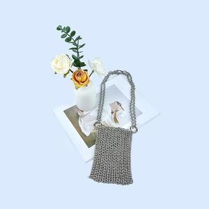 Detail view of silver chainmail mini bag handcrafted with shimmering metallic link texture