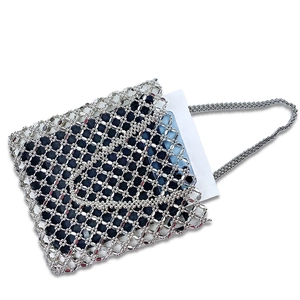 Close-up of silver beaded tote bag showing hollow grid texture and storage capacity