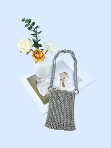 Elegant silver handwoven chainmail crossbody phone bag with shimmering metallic finish