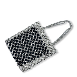 Detail of silver beaded handmade woven tote featuring a removable black fabric liner
