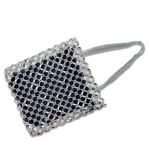 Macro detail of hand-woven silver metal beads and black fabric lining on tote bag