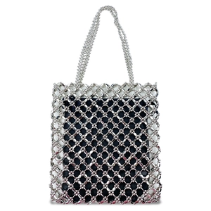 Macro shot of silver metal beaded mesh tote bag with a dark blue fabric lining