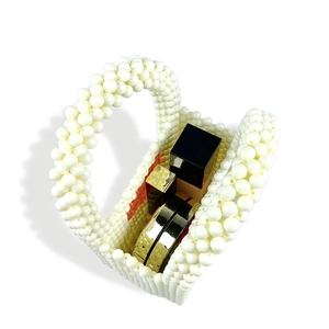 Macro view of white beaded pearl mini handbag showing internal storage capacity