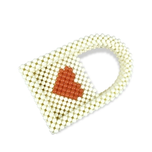 Detail view of handmade beaded mini tote bag featuring a red heart pattern on white beads