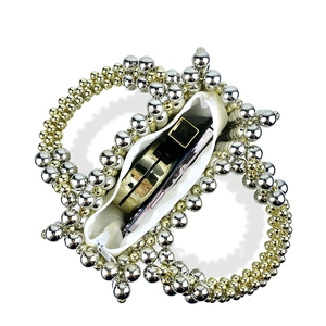 Detail of silver beaded handbag showing interior space with phone and satin lining