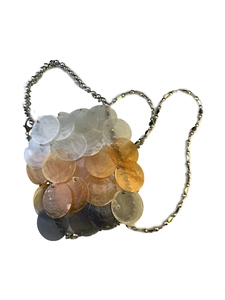 Detail of colorful seashell disc handbag with beaded chain strap and pearlescent finish