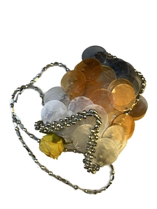 Detail of colorful handmade shell handbag with overlapping discs and silver beaded chain