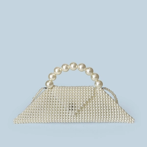 Detail view of a handcrafted pearl triangle handbag with glossy white beaded texture