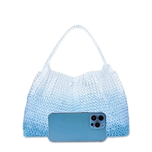 Detail of blue ombre beaded handbag with crystal beads and matching handle shown with a phone