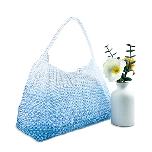 Detail showing handcrafted blue and white gradient beaded tote bag for summer beach travel