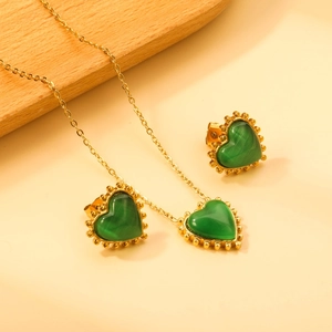 Vintage stainless steel jewelry set featuring green cat eye heart pendant and stud earrings