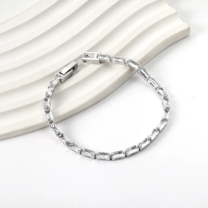 Détails macro d'un bracelet tennis argenté avec zircons rectangulaires de taille baguette