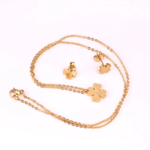 Detailed view of golden frosted clover jewelry set including necklace and stud earrings