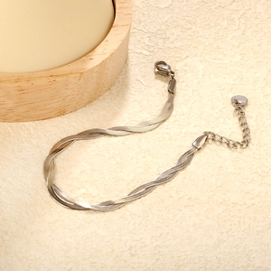 Macro detail of silver double-layered twisted snake chain bracelet with lobster clasp