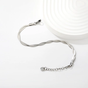 Detail of silver double layered herringbone snake chain bracelet with lobster clasp and tag
