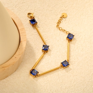 Bracelet articulé plaqué or 18 carats avec barres fines et pierres bleues carrées