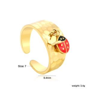 Detail of wide 18K gold plated textured ring with ladybug and butterfly charms