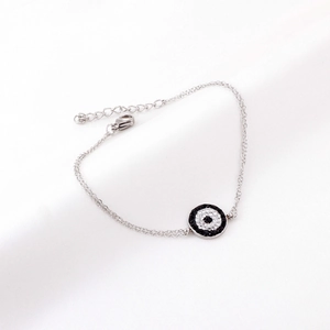 Detail of silver dual-chain evil eye bracelet with micro-paved zirconia stones and clasp