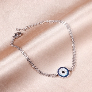 Double-layered stainless steel bracelet featuring a blue devil's eye charm with crystals