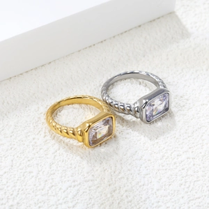 Close-up of rectangular green zirconia rings with a unique braided metal texture band