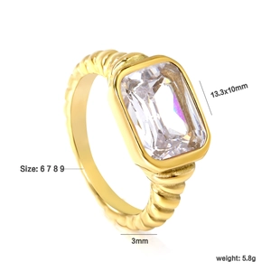 Close-up of 18K gold ring with emerald-cut zirconia and twisted rope band detail
