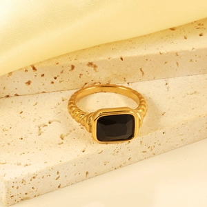 Detail of vintage 18K gold plated ring featuring a large rectangular black gemstone