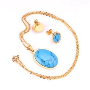 Detalle del conjunto de collar y pendientes dorados con piedras turquesas ovaladas