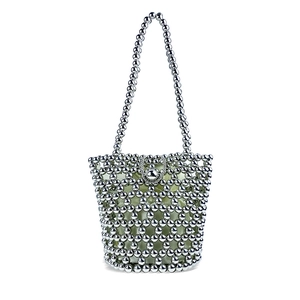 Detailed shot of silver beaded handbag with star-patterned weave and pale green lining
