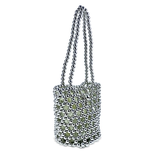 Detail of silver beaded bucket bag with mesh texture and drawstring inner pouch