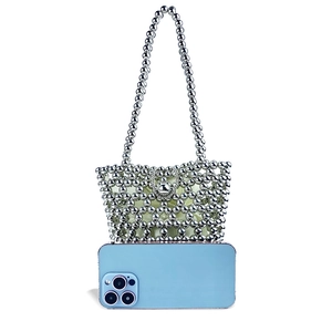 Detail of silver metallic beaded bucket bag showing hollow structure and bead chain strap