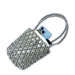 Silver beaded handbag macro showing internal capacity with a smartphone inside