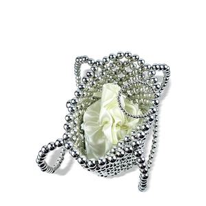 Close-up of a silver beaded bucket bag with a cream satin drawstring inner pouch