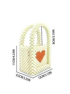 Handmade beaded mini pearl bag with red heart pattern and dual handles on white background