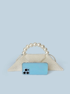 Handmade pearl bead handbag in unique geometric shape with circular handle and phone for scale