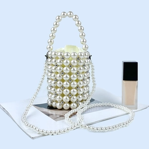 Detailed view of handmade pearl beaded bucket bag with drawstring liner and handle
