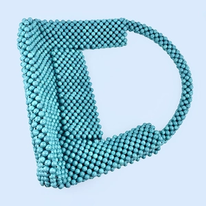 Detail of turquoise beaded handbag showing handmade woven texture and marbled round beads
