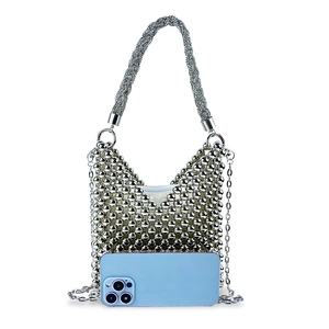 Detail of silver beaded handbag with woven texture and metal chain strap for size reference