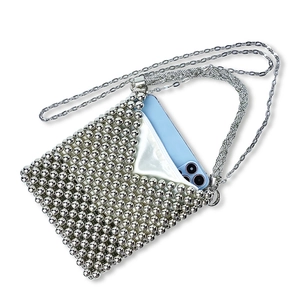 Detail of silver beaded mini crossbody bag with metal chain strap and satin lining
