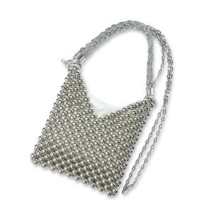Close-up of handmade silver beaded shoulder bag featuring intricate woven metal texture