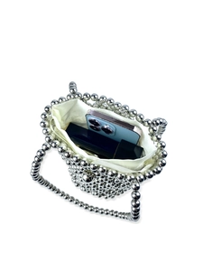 Silver beaded bucket bag with inner lining showing capacity for a smartphone