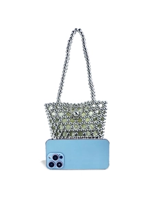 Silver beaded woven bucket bag with chain handle and yellow satin lining on white background
