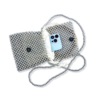 Detailed view of silver beaded bag interior with lining showing mobile phone capacity