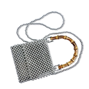 Close-up of metallic beaded square handbag featuring vintage bamboo handle and chain