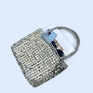 Macro view of silver sequin beaded tote bag showing interior storage capacity
