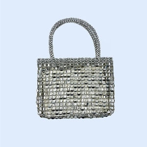 Detailed view of silver sequin beaded tote bag with reflective metallic surface