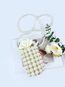 Handcrafted pearl beaded bucket bag with gold accents and drawstring satin lining