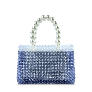 Detail of blue and clear beaded handbag with elegant white pearl handle on white background