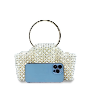 Beaded pearl evening handbag with large gold metal ring handle and smartphone for scale