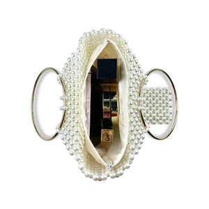 Top view of pearl beaded bag showing satin lining and capacity for phone and cosmetics
