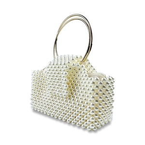 Detail view of woven pearl evening bag featuring golden metal handles and white zipper closure